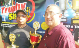 President of the GRFU, Peter Green (right) displays one of the trophies

