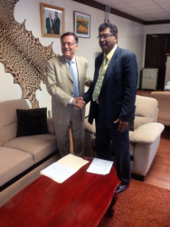 Public Security Minister Khemraj Ramjattan meeting Argentine Ambassador to Guyana Luis A. Martino at the Ministry of Public Security, Brickdam on Wednesday September 30, 2015. The Jaguar skin is clearly visible on the wall.