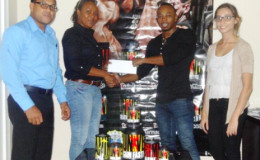  IPA Sales and Marketing Manager, Atisha Isaacs (left) hands over the sponsorship package to Men’s Physique champion, Emmerson Campbell in the presence of the company’s Managing Director, Reginald Persaud and Telemarketer, Fleur Blanckaert. 
