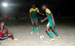 Jamal Codrington (left) of Alpha United lying on the ground after getting disposed of possession by his GDF marker during their team’s matchup in the GFF Stag Beer Elite League
