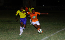 Jermin Junior (right) of Fruta Conquerors trying to maintain possession of the ball while being challenged by a Pele player during their team’s GFF Stag Beer Elite League fixture at the Tucville Community ground.