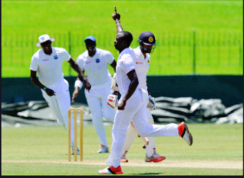 Fast bowler Kemar Roach celebrates after taking one of this two wickets on yesterday’s second day. (Photo courtesy WICB Media) 