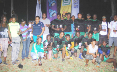 Winners of the GRFU/Trophy Stall Championships, UG Wolves (male) and the Over-35 unit (female) pose with their hardware following yesterday’s tournament at the University of Guyana Campus ground. (Orlando Charles photo) 