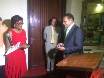 Minister of Tourism Cathy Hughes receives gift from mayor of St  Laurent du Maroni Leon Bertrand with Sous -prefet in centre at a civic reception at the town hall 