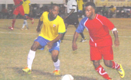 Kevin Cottoy (right) of Monedderlust FC trying to evade the pursuit of Pele’s Ronel Gordon during the latter team’s win in the GFF Stag Beer Elite at the GFC ground (Orlando Charles photo)