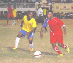 Kevin Cottoy (right) of Monedderlust FC trying to evade the pursuit of Pele’s Ronel Gordon during the latter team’s win in the GFF Stag Beer Elite at the GFC ground (Orlando Charles photo) 