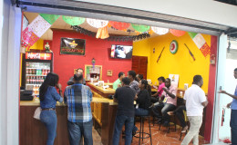 Some of the guests who were offered samples of the food available at Mexican Taco. (Photo by Keno George)
