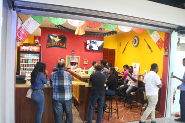 Some of the guests who were offered samples of the food available at Mexican Taco. (Photo by Keno George) 