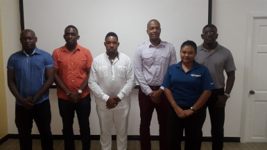 The newly elected members of the GFA Mark Younge (right), Andrew Major (2nd right), Kenrick Noel (centre) and Rawle Adams (left) pose with GFF Chairman Clinton Urling (3rd from right) and General Secretary Diedre Davis (2nd from right) following the conclusion of the elections. 
