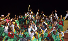 The GDF track and field outfit posing with the winner’s Inter Services Annual Athletic Championship Trophy. 
