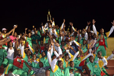 The GDF track and field outfit posing with the winner’s Inter Services Annual Athletic Championship Trophy.  
