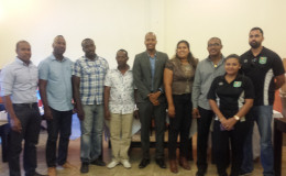 Newly elected GFA President Clifton Hicken (4th left) posing with members of the newly elected executive inclusive of Aaron Fraser (left), Frank Parris (2nd left), Lloyd Millington (3rd left), Althea Scipio (4th right), Charles Greaves (3rd right) while GFF Normalization Committee Chairman Clinton Urling (centre), GFF General Secretary Diedre Dave (2nd right) and Normalization Committee member Tariq Williams (right) share the moment.
