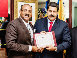  PM Gaston Browne (left) presents President Nicolas Maduro with the shares certificate for the oil company. (Office of the Antigua Prime Minister)