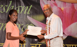 President David Granger handing over a certificate to valedictorian and Guyana’s top performer at this year’s CSEC, Victoria Najab. (Ministry of the Presidency photo)