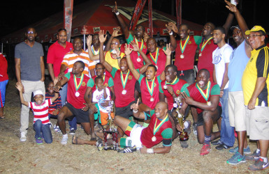 Winners of the Banks 7s Championship trophy, GDF pose with their hardware following yesterday’s tournament at the University of Guyana Campus ground. (Orlando Charles photo) 