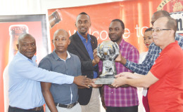 Director of Sport Christopher Jones (3rd from left) posing with members of the Banks Beer Inter Ministry/Corporation Futsal Tourney launch party inclusive of Banks DIH Limited Communications Officer Troy Peters (left), Tourney Co-Coordinators Otis James (2nd from left) and Esan Griffith (centre), Ministry of Tourism Representative Cathy Martin (3rd from right), GFF Director of Marketing and Communications Rawle Toney (2nd from right) and Banks Beer Executive Brian Choo-Hen (right) 