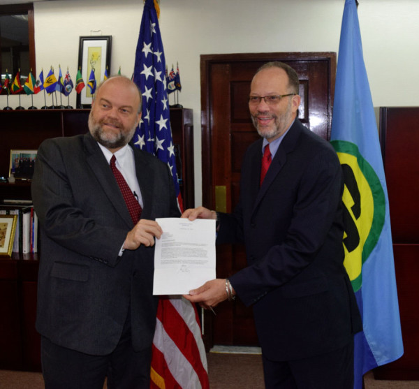 Perry Holloway (left) presenting his credentials to Caricom Secretary General Irwin LaRocque (Caricom photo)