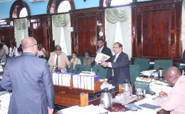 Prime Minister Moses Nagamootoo (right) and Opposition Leader Bharrat Jagdeo (left) bantering about salary hikes and pensions in parliament yesterday.