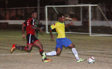 Gregory Richardson (right) of Pele FC on the attack on the right side of the field while being pursued by Alpha United’s Quincy Madramootoo during the former team’s win at the Camp Ayanganna ground in the GFF Stag Beer Elite League. 
