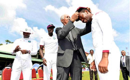 Sir Garry Sobers presents Jomel Warrican with his first Test cap on the opening day of the second Test against Sri Lanka on Thursday. (Photo courtesy WICB Media)