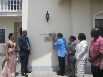 Prime Minister Moses Nagamootoo unveils the plaque for the opening of the Demerara Paradise Inc Nursing Home. Also in picture are (from left) Directors Dr Carolina Bridgemohan, Dr Vivekanand Bridgemohan, Mrs Sita Nagamootoo, Junior Public Health Minister Dr Karen Cummings and Social Protection ministerial advisor John Adams.