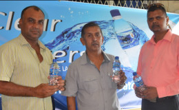 Marketing, Sales and Distribution Manager of Clear Waters, Narendra Lucknauth (right), GFSCA President Ramchand Ragbeer (centre) and Vice-president of the GFSCA, Ricky Deonarain, display a bottle of Clear Waters.