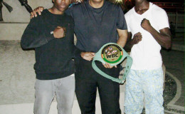 Vice President of NexGen Global Marketing Services Inc. Aleem Hussain (centre) is seen posing with the ‘Caribbean Knockdown’ card headliners Clive Atwell and Dexter Gonsalves prior to the fight last Saturday at the Giftland Mall.
