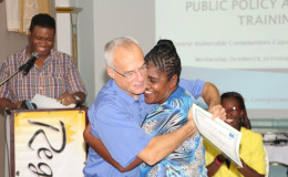 One of the participants in the advocacy training programme collects her certificate from lead facilitator Gordon Floyd. (Keno George photo)