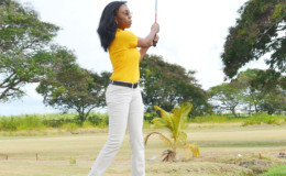 Digicel marketing head Jacqueline James tees of yesterday morning during the official opening of the tournament.