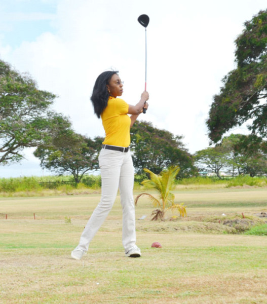 Digicel marketing head Jacqueline James tees of yesterday morning during the official opening of the tournament.  