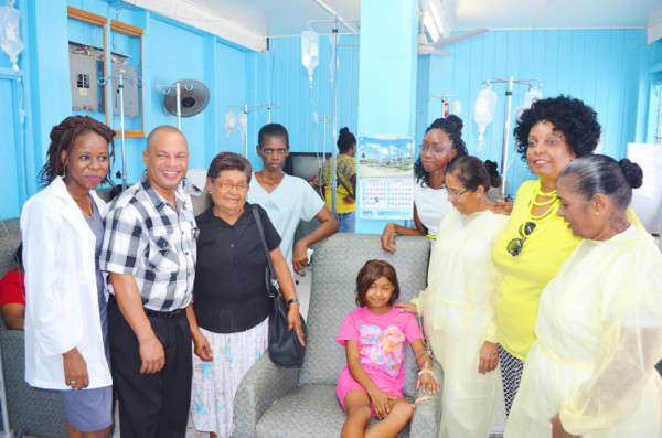 Dr Latoya Gooding (left) and her team pose with Shelly Debidin (centre), the Oncology Consultant (second, left), Shelly’s grandmother Celestine DeFreitas (third, left) and members of OSHAG. 