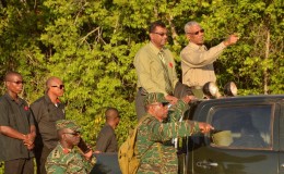 President David Granger (pointing) observing the advance and attack phase of the exercise. Next to him is Public Security Minister, Khemraj Ramjattan.