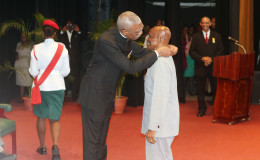 In this Keno George photo, President David Granger presents the national award. The ceremony was held at the National Cultural Centre.