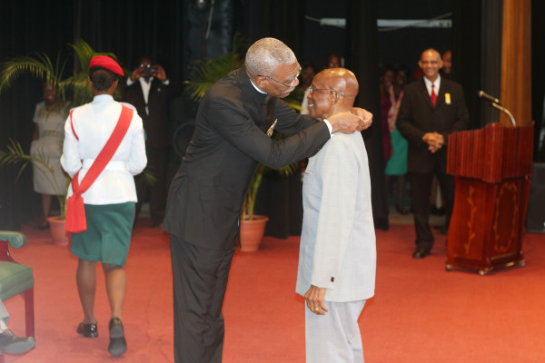 In this Keno George photo, President David Granger presents the national award. The ceremony was held at the National Cultural Centre.
