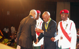 President David Granger (left) congratulating Bryn Pollard SC on his national award of the Order of Roraima for his “contributions in the field of law at the National, Regional, Commonwealth and International levels.” The ceremony was held at the National Cultural Centre today. (Keno George photo)