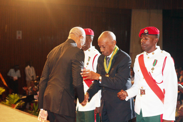 President David Granger (left) congratulating Bryn Pollard SC on his national award of the Order of Roraima for his “contributions in the field of law at the National, Regional, Commonwealth and International levels.” The ceremony was held at the National Cultural Centre today. (Keno George photo)