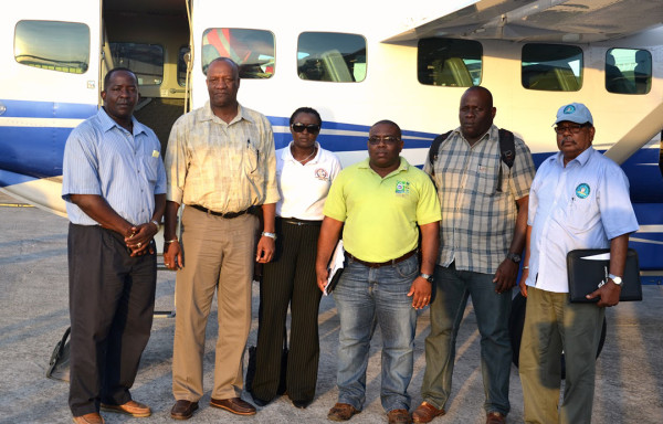 Minister of State, Joseph Harmon (second from left) , with his delegation at the Ogle Airport. At far right is Director General of the Civil Defence Commission (CDC) Colonel Chabilall Ramsarup  (Minister of the Presidency photo)