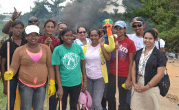 First Lady Sandra Granger (centre at back) with the Self Reliant Women's Group and volunteers during this morning's clean up efforts. (Ministry of the Presidency photo)