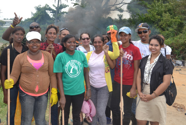 First Lady Sandra Granger (centre at back) with the Self Reliant Women's Group and volunteers during this morning's clean up efforts. (Ministry of the Presidency photo)
