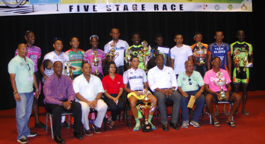 The principals and the prize winners of this year’s five-stage road race pose for a photo opportunity following the closing ceremony yesterday at the National Cultural Centre. (Orlando Charles photo) 