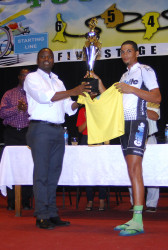  Team Gillette Evolution’s Raul Leal accepts his winner’s trophy from Director of Youth, Trevor Williams yesterday at the National Cultural Centre. (Orlando Charles photo) 