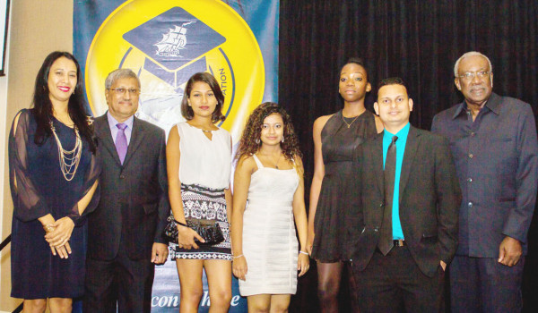 From left are Secretary Sharon Sue-Hang, DDL Chairman Komal Samaroo, Awardees Chelsea Balkarran, Fareeda Bacchus, Natasha Loncke, DDL CFO Vasudeo Singh and DDL Foundation Chairman Rudy Collins. (DDL photo)