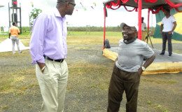 Minister of Public Infrastructure David Patterson (left) speaking to a resident of the area  (Ministry of Public Infrastructure photo)