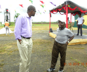 Minister of Public Infrastructure David Patterson (left) speaking to a resident of the area  (Ministry of Public Infrastructure photo)