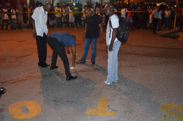 Police Detectives marking the location of discharged rounds (Photo by Dhanash Ramroop) 