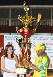 REGALLY YOURS! Captain of the victorious Regal Masters softball team Troy Kippins receives the winning trophy from the Masters division from Devi Sunich, wife of Ramesh Sunich proprietor of Trophy Stall, an organization which is to the fore of sports sponsorship in Guyana through their generous donations of trophies for a wide range of sporting endeavours.