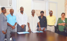 Chief Statistician Lennox Benjamin (centre), Managing and Technical Director of Project design and Construction Inc Aubrey Changlee (third from left) and other senior members of the Bureau of Statistics following the contract signing (GINA photo)
