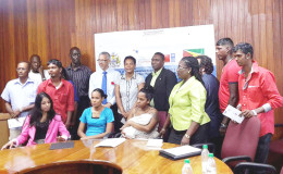 The recipients with the Minister of Business Dominic Gaskin and other officials