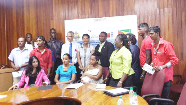 The recipients with the Minister of Business Dominic Gaskin and other officials