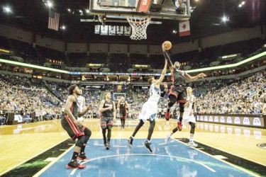  Minneapolis, MN, USA; Miami Heat guard Dwyane Wade (3) goes up for a layup past Minnesota Timberwolves guard Kevin Martin (23) in the second half at Target Center. The Heat won 96-84. Mandatory Credit: Jesse Johnson-USA TODAY Sports. 
